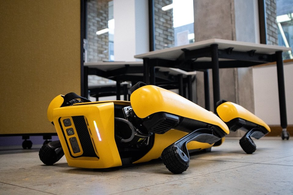 Boston Dynamics' Spot robot resting on the Makerspace floor.