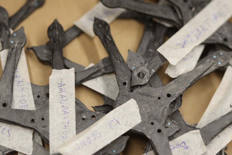 Cut structural parts arranged on a workshop table.