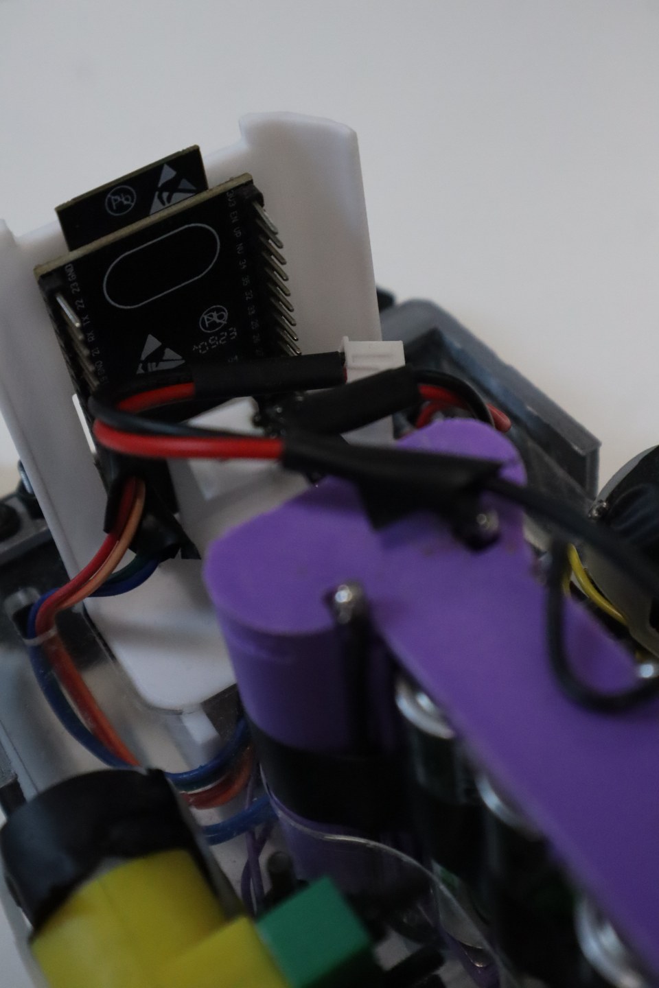 Close-up of a purple and black student-built wheeled robot.