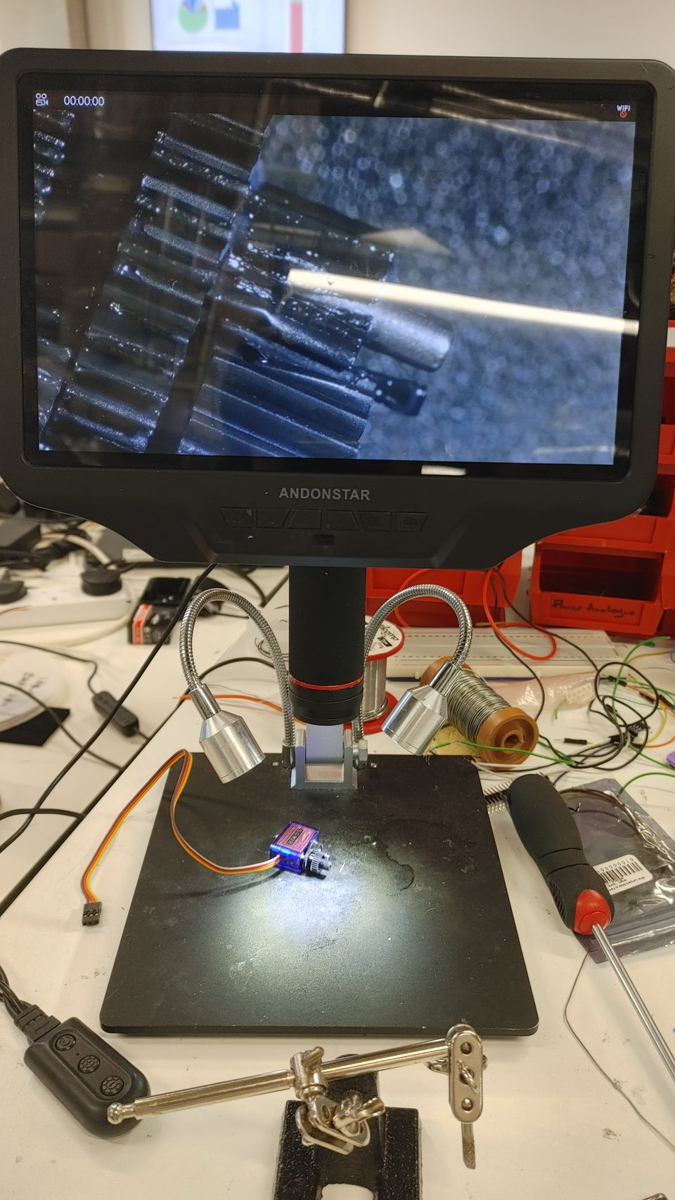 A close-up inspection camera above an electronics workbench.