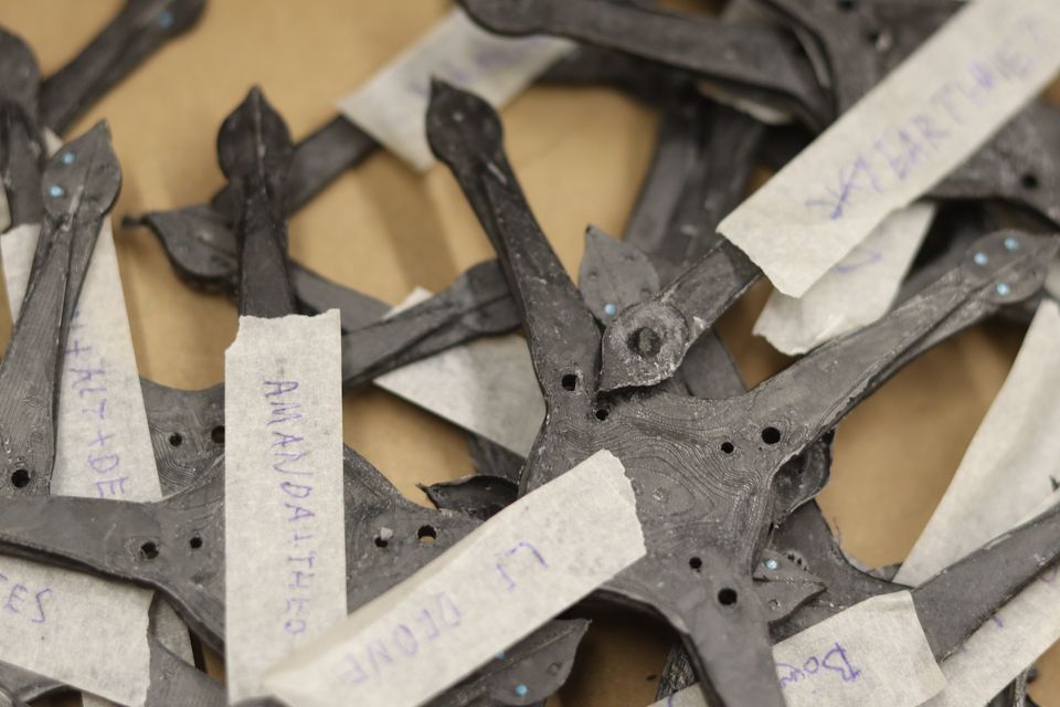 Cut structural parts arranged on a workshop table.