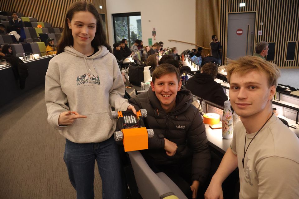 A group of students presenting robots at a society stand.