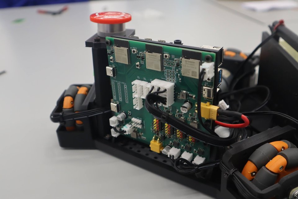A close view of a Eurobot drivetrain with its control board and wiring exposed.