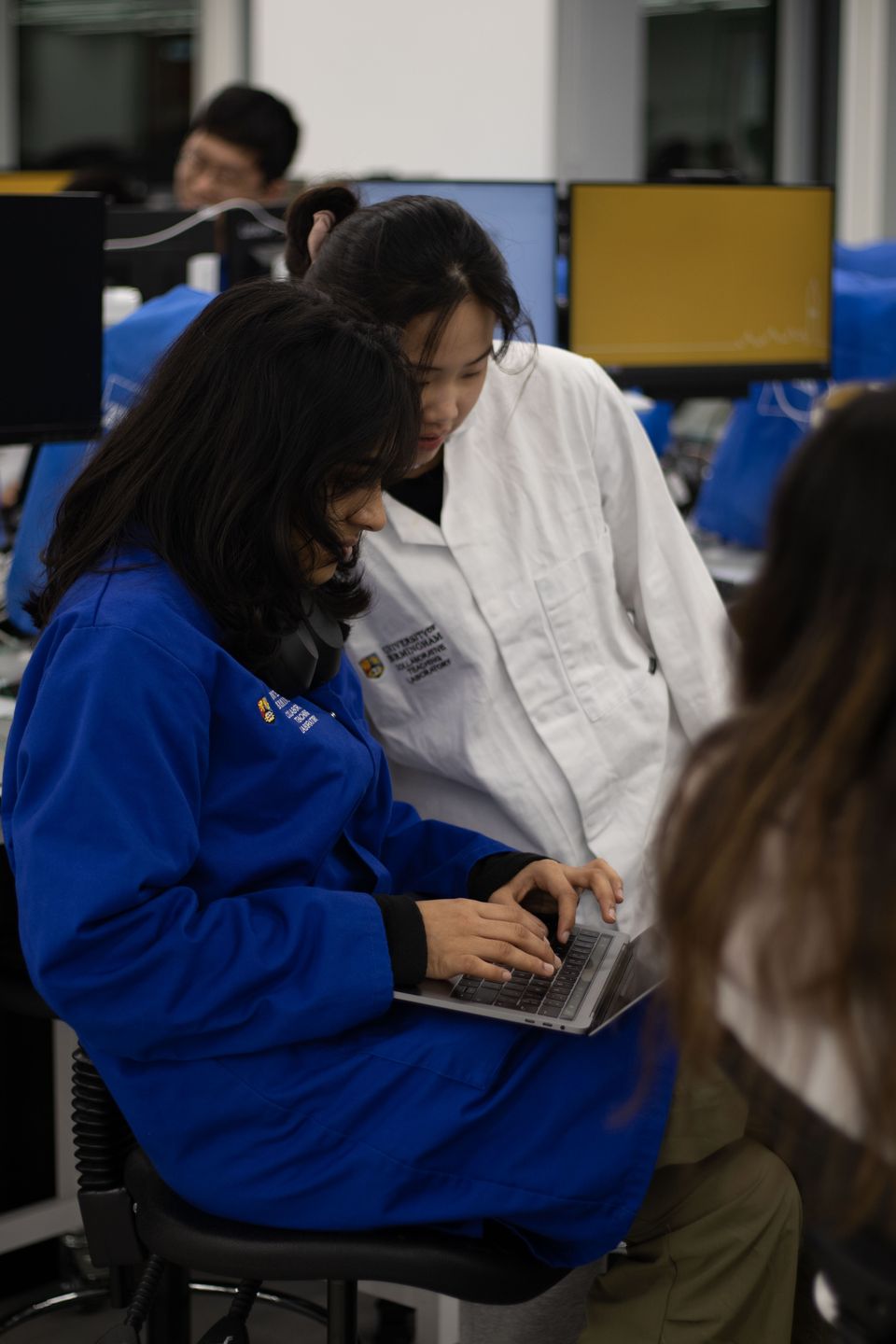 A workshop participant concentrating on a small electronics project.