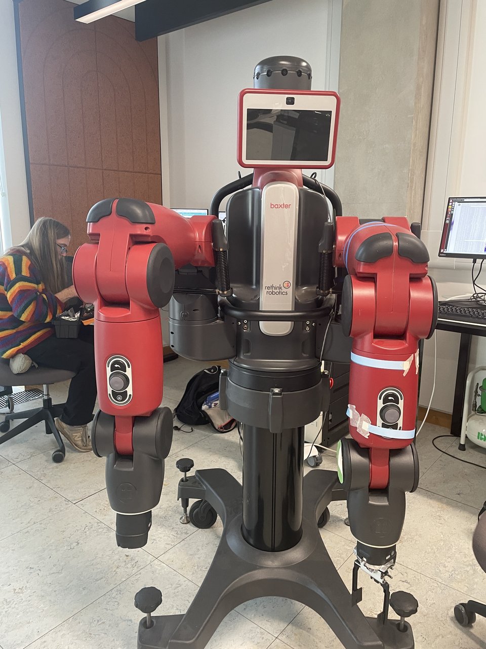 A red and black Baxter research robot standing in the Makerspace.