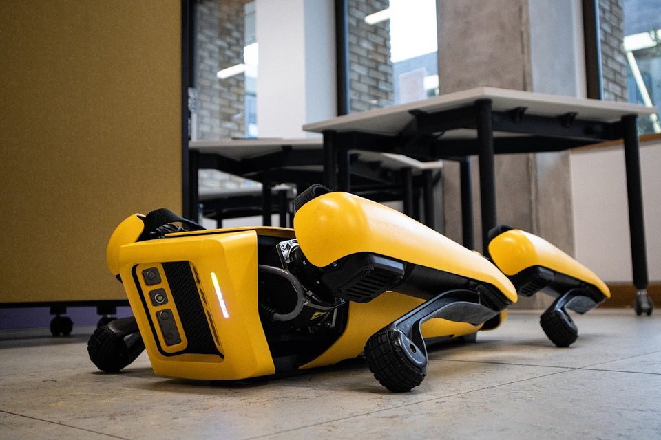 Boston Dynamics' Spot robot resting on the Makerspace floor.